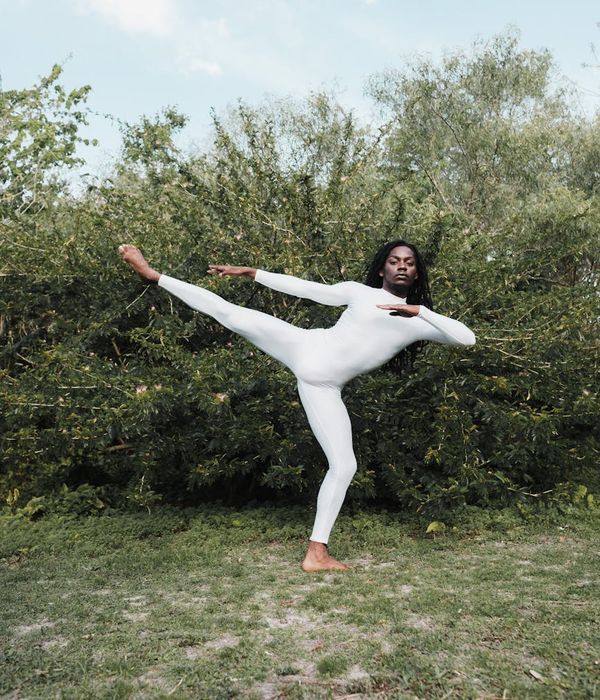 Woman performing a slow, controlled cardio movement in a calm environment.